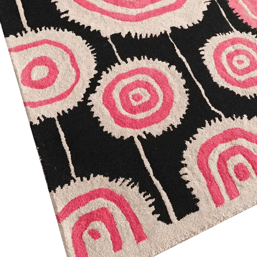 This Orbit Bloom Hand Tufted Rug features a striking abstract design with bold pink and cream circular patterns on a black background, perfect for adding a vintage touch to living room and dining room spaces. Ideal as an 8x10 area rug, this wool rug combines style and comfort for any modern decor.