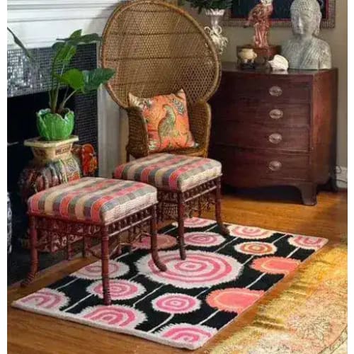 A vibrant area rug in a cozy living room setting, featuring a colorful abstract design with pink and black swirls, perfect for adding a touch of vintage charm to a dining room or living room. The hand-tufted wool rug complements the eclectic decor, ideal for living room rugs 8x10.