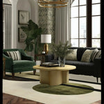 A stylish living room featuring the Orbital Harmony Hand Tufted Rug, a contemporary area rug perfect for dining rooms and living spaces. The wool rug displays a modern design with geometric patterns in green and beige tones, complementing the elegant furniture and decor.
