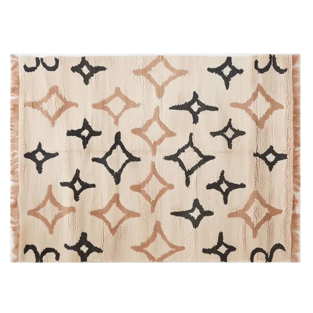 An elegant Orbitals Knotted Wool Rug featuring a contemporary design with abstract star patterns in black and beige on a cream background. This area rug is perfect for adding a modern touch to any living room, with its 8x10 size making it an ideal choice for spacious areas.