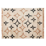 An elegant Orbitals Knotted Wool Rug featuring a contemporary design with abstract star patterns in black and beige on a cream background. This area rug is perfect for adding a modern touch to any living room, with its 8x10 size making it an ideal choice for spacious areas.