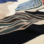 Close-up of a multicolored abstract patterned rug.