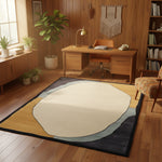 Home office with wooden desk, chair, and decorative rug on wooden floor.