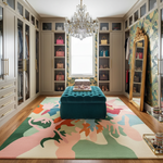 Luxurious bedroom with a colorful rug, teal ottoman, and decorative shelves.