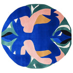 A vibrant, hand-tufted round area rug with an abstract design featuring bold blue, pink, green, and mustard colors. Perfect as a contemporary rug, this wool rug adds a splash of color and style to any living room, making it an ideal choice for those seeking unique area rugs for living room decor.