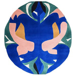 This vibrant, hand-tufted round area rug showcases an abstract design with bold colors like blue, pink, green, and tan. Its contemporary style makes it an ideal choice for adding a modern touch to your living room. Made from high-quality wool, this rug not only enhances the aesthetic appeal but also provides a cozy feel underfoot.