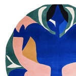 A vibrant and contemporary hand-tufted round area rug featuring an abstract design in blue, pink, green, and white colors. Perfect for adding a modern touch to any living room, this wool rug combines artistic flair with functionality, making it an ideal choice for those seeking stylish area rugs for living room spaces.