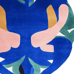 Vibrant and artistic area rug featuring a unique abstract design with bold blue, pink, and green shapes. This contemporary wool rug is perfect as a round rug for living rooms, adding a splash of color and creativity to your space.