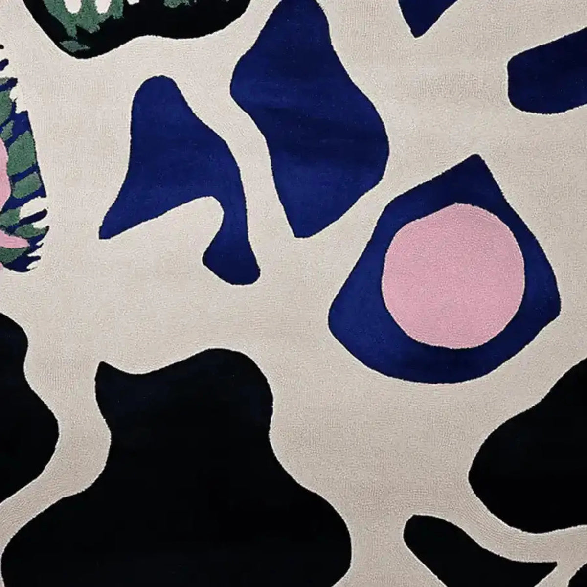 This image showcases a contemporary wool area rug with an abstract design featuring bold, organic shapes in navy blue, black, and pink against a cream background. Perfect for large living room spaces, this hand-tufted rug adds a modern touch to any decor, ideal for those seeking stylish area rugs for living room settings.