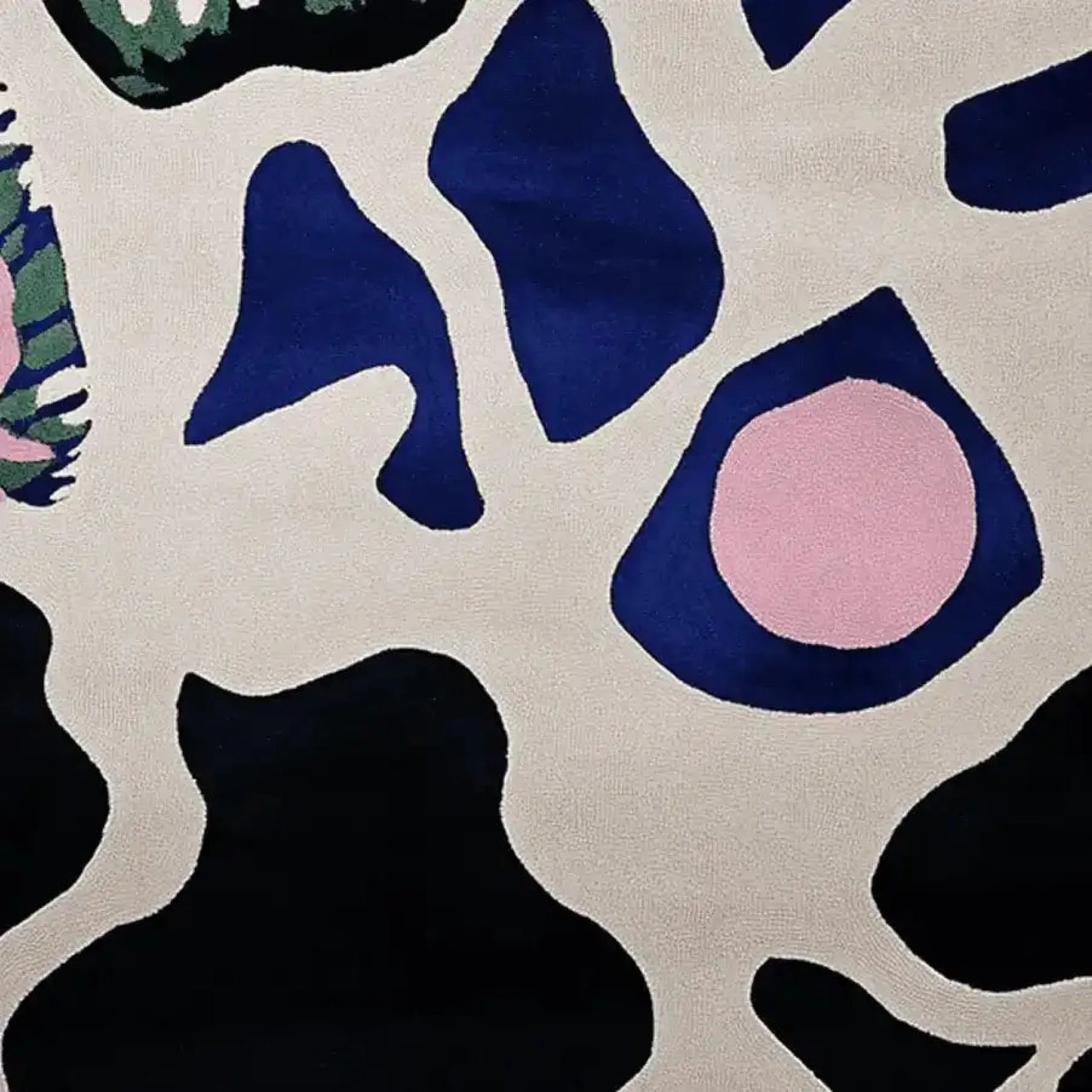 This image showcases a contemporary wool area rug with an abstract design featuring bold, organic shapes in navy blue, black, and pink against a cream background. Perfect for large living room spaces, this hand-tufted rug adds a modern touch to any decor, ideal for those seeking stylish area rugs for living room settings.