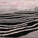 Close-up of black and white striped fabric with a blurred background
