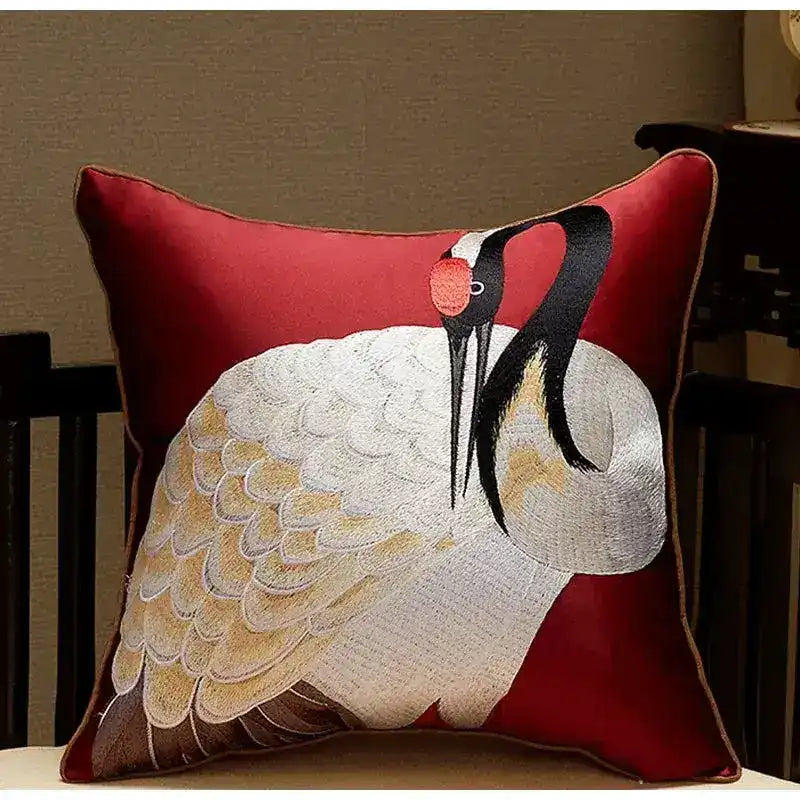 Oriental crane embroidered satin throw pillow cover featuring intricate detailing on a vibrant red background.