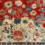 A stunning Oriental Elegance Hand Tufted Rug featuring a vibrant floral design with red, blue, and beige tones. This large 8x10 wool area rug, ideal for a living room, showcases vintage charm and intricate patterns, making it a perfect centerpiece among living room rugs.