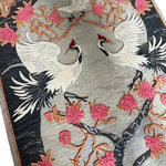 Close-up of the Oriental Reverie Hand Tufted Area Rug featuring elegant cranes and vibrant pink floral designs. This beautiful wool rug is perfect for adding a touch of nature to your bedroom or living room.