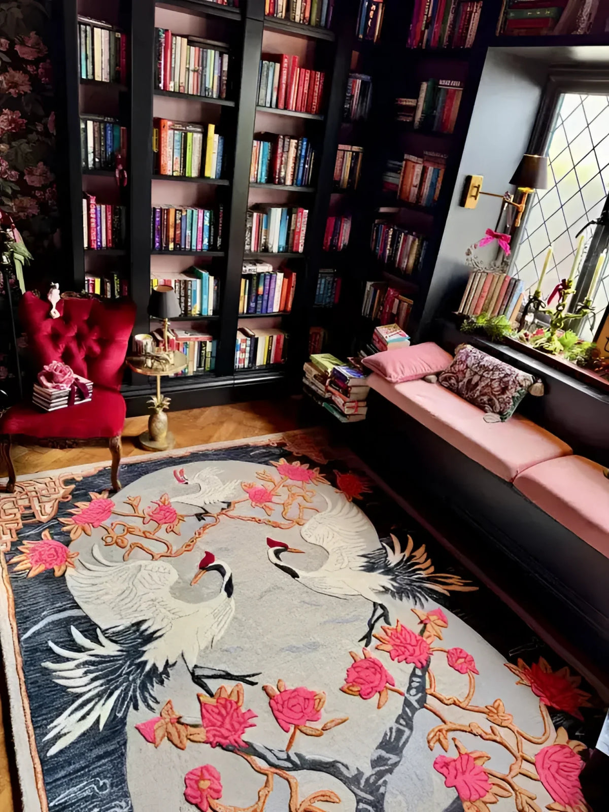 Cozy reading nook featuring a stunning Oriental Reverie hand-tufted area rug with an intricate floral design, perfect for bedroom or living room decor. The elegant wool rug complements the surrounding bookshelves and plush seating, creating a warm and inviting atmosphere.