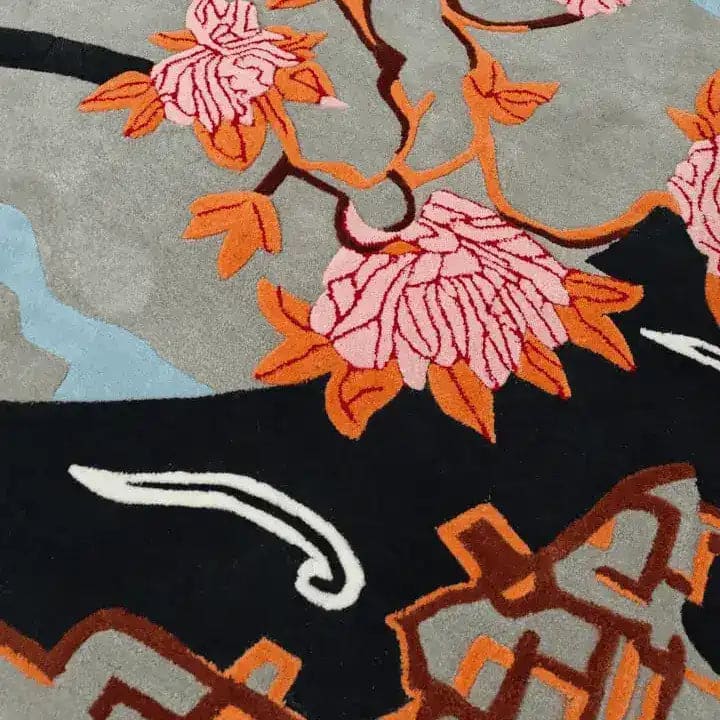 Close-up of the Oriental Reverie Hand Tufted Area Rug featuring intricate floral designs in vibrant pink and orange hues on a gray background. Perfect for adding elegance to bedrooms or living rooms, this wool rug combines artistry and comfort, making it an ideal choice for bedroom area rugs.