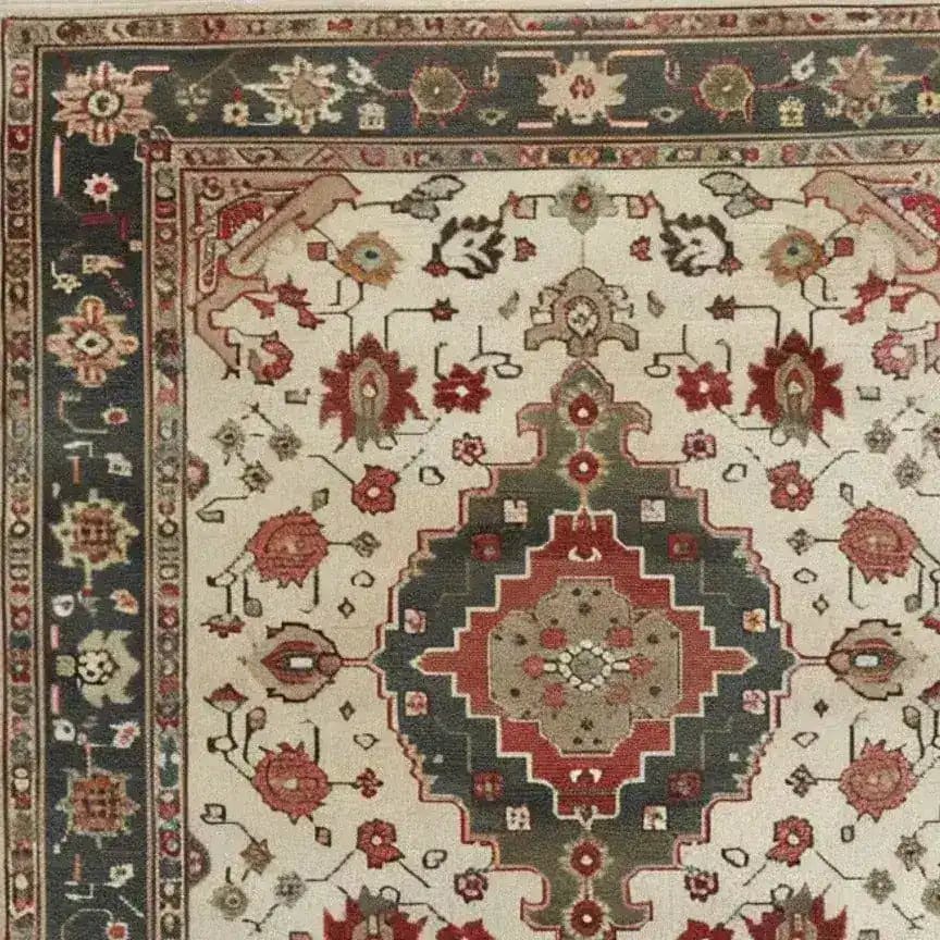 Close-up of an ornamental floral hand-knotted area rug showcasing a vintage Persian design. The intricate pattern features vibrant reds and greens with floral motifs, perfect for adding elegance to living room areas. Ideal for 8x10 spaces, this rug offers a timeless and sophisticated touch.