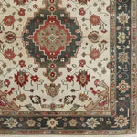 This is a detailed view of an ornamental floral hand-knotted area rug, showcasing intricate Persian-inspired designs with a vintage charm. The rug features a central medallion surrounded by rich floral patterns, making it a perfect addition to any living room setting. Its 8x10 size ensures it covers a substantial floor area, providing both style and comfort to your space.