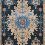 A beautifully detailed area rug featuring a vintage floral pattern with intricate designs in blue and beige tones. Perfect as a dining table rug or a wool rug for the dining room, this ornate blooms hand tufted rug adds a touch of elegance to both living room and dining room spaces.
