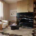 A beautifully styled living room featuring an Ornate Echo Hand Tufted Area Rug, adding elegance and warmth to the space. This wool rug, with its vintage-inspired design, is perfect for large living rooms seeking a touch of sophistication. The rug's intricate patterns complement the modern decor, making it an ideal choice for those looking for living room area rugs that combine style and comfort.