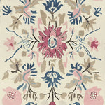 This hand-tufted wool rug features an intricate floral design with vibrant pink, blue, and beige hues. Perfect for adding a touch of elegance to any living room, this large area rug combines beauty and functionality. Ideal for those searching for living room area rugs that offer both comfort and style.