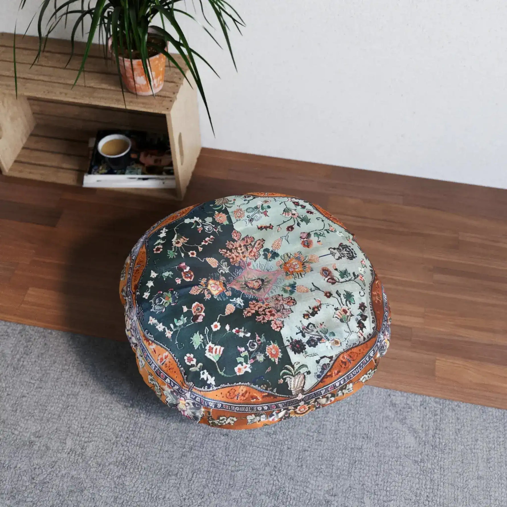 Ornate Floral and Geometric Floor Pillow with dark-teal and sage floral panels and copper border, placed on wood floor in a room setting