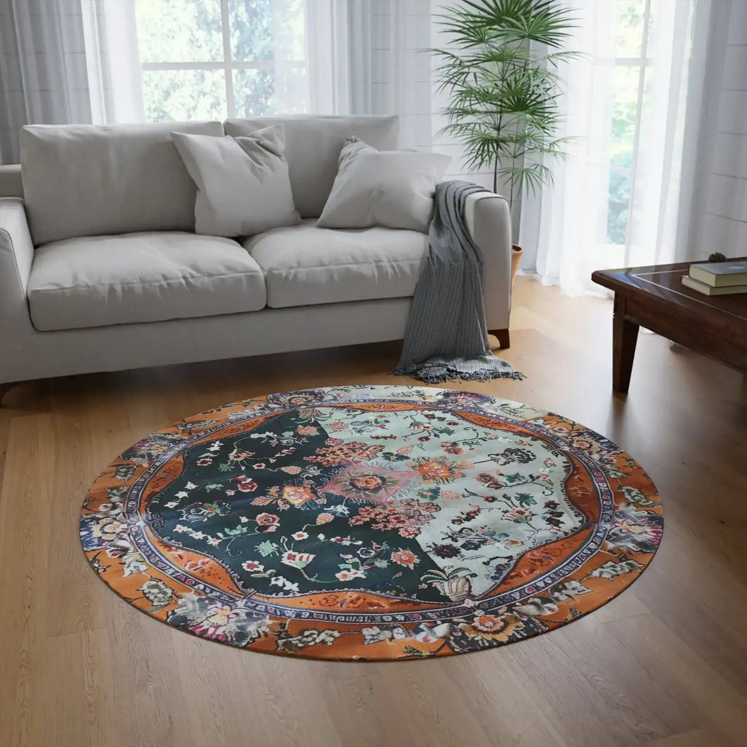 Ornate Floral and Geometric round rug in bright living room with gray sofa and wood floor, bold color contrast pattern visible