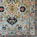 Intricately designed ornate floral harmony area rug, hand-knotted with viscose and wool, showcasing vibrant vintage patterns. Perfect for adding a touch of elegance to a dining room or bedroom. This Persian-style wool rug combines traditional motifs with modern flair, ideal for formal dining room settings or cozy bedroom retreats.