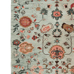 A beautifully detailed area rug showcasing an ornate floral pattern in warm tones. This hand-knotted wool rug is perfect for adding elegance to living rooms, especially in an 8x10 size. The intricate design features a blend of traditional and contemporary floral motifs, making it an ideal choice for those seeking stylish and durable rugs for living room settings.