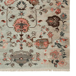 Ornate hand-knotted area rug featuring an intricate floral pattern, perfect for adding elegance to your living room. This wool rug showcases a harmonious blend of earthy tones and vibrant colors, ideal for 8x10 spaces.