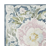 This image showcases a beautifully detailed corner of the Ornate Flower Twist Hand Tufted Rug, featuring a vibrant floral design with soft pastel colors and intricate patterns. Ideal for adding elegance to any living room, this wool rug is perfect as an 8x10 area rug, enhancing any space with its artistic charm.
