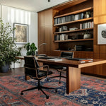 A beautifully styled modern office featuring a large area rug with vintage design. The Ornate Mirage Hand Tufted Rug adds a touch of elegance to the space, highlighting its intricate patterns in a rich wool texture. Perfect for those seeking a living room rug 8x10 that brings both style and warmth.