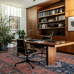 A beautifully styled modern office featuring a large area rug with vintage design. The Ornate Mirage Hand Tufted Rug adds a touch of elegance to the space, highlighting its intricate patterns in a rich wool texture. Perfect for those seeking a living room rug 8x10 that brings both style and warmth.