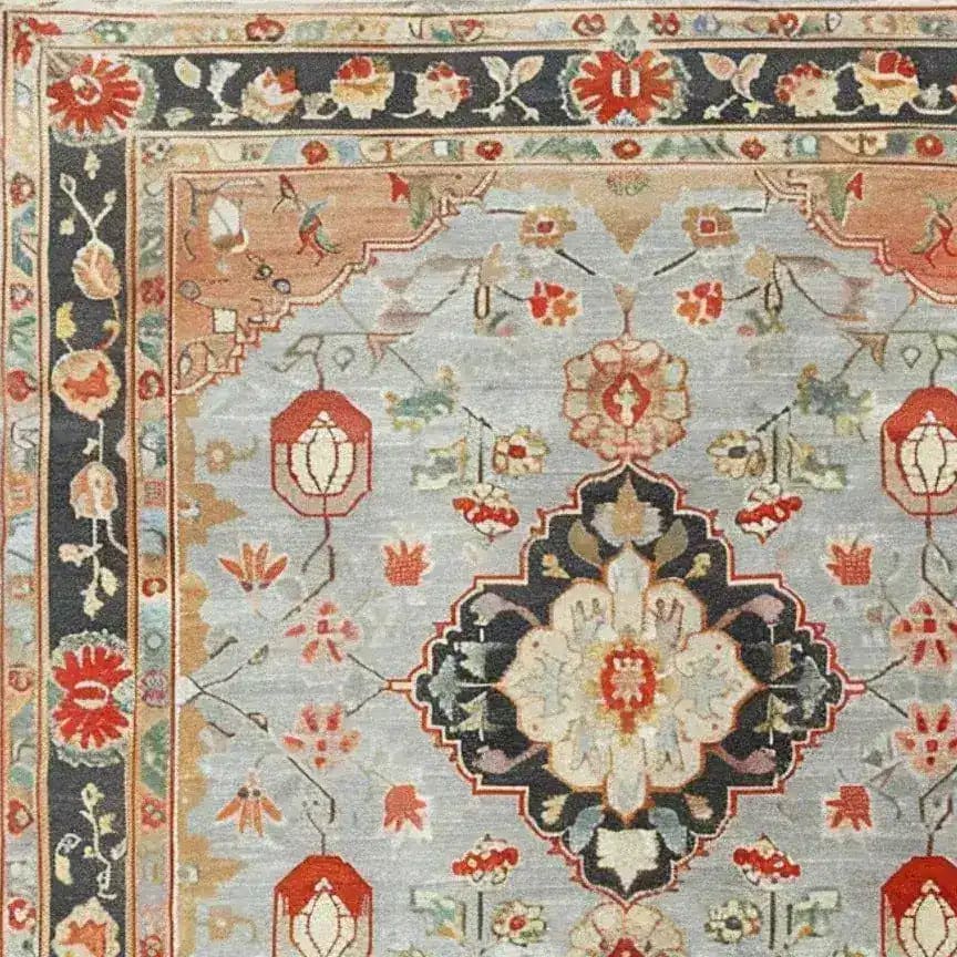 Close-up of an ornate shadow floral hand-knotted area rug showcasing intricate floral patterns and vintage designs. This Persian-inspired rug is perfect for adding elegance to living room spaces, blending traditional aesthetics with modern decor.