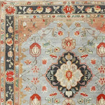 Close-up of an ornate shadow floral hand-knotted area rug showcasing intricate floral patterns and vintage designs. This Persian-inspired rug is perfect for adding elegance to living room spaces, blending traditional aesthetics with modern decor.