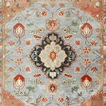 A detailed view of an ornate shadow floral hand-knotted area rug, showcasing a beautiful vintage floral pattern with intricate Persian designs. This living room area rug features a harmonious blend of colors, including soft blues, reds, and earthy tones, making it a perfect choice for adding a touch of elegance to your home decor.