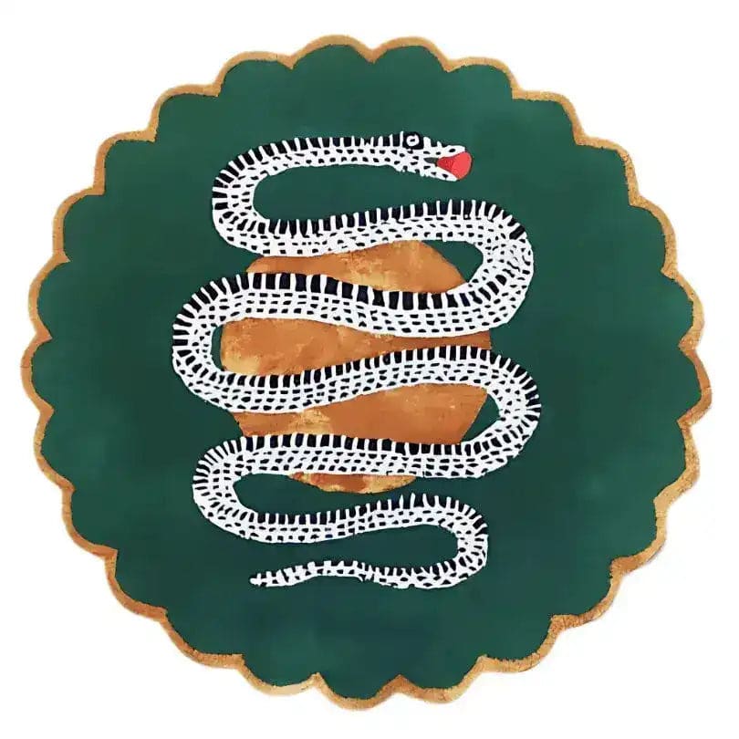 Overhead view of dark green scalloped snake rug, white serpent with red tongue over a gold apple