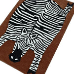 A stylish oversized zebra hand tufted wool rug, perfect for adding a unique touch to your dining room or living room. This area rug features a striking zebra design on a rich brown background, ideal for those seeking distinctive living room area rugs or dining room area rugs.