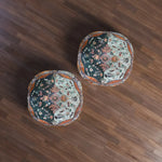 Pair of Ornate Floral and Geometric Floor Pillows with dark-teal and light-blue floral panels and copper border, styled together on dark wood floor