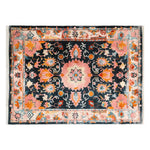 This vibrant area rug features an intricate floral pattern with bold pink, orange, and blue hues, making it a standout wool rug for any living room. The hand-tufted design adds a touch of elegance, perfect for enhancing your home decor.