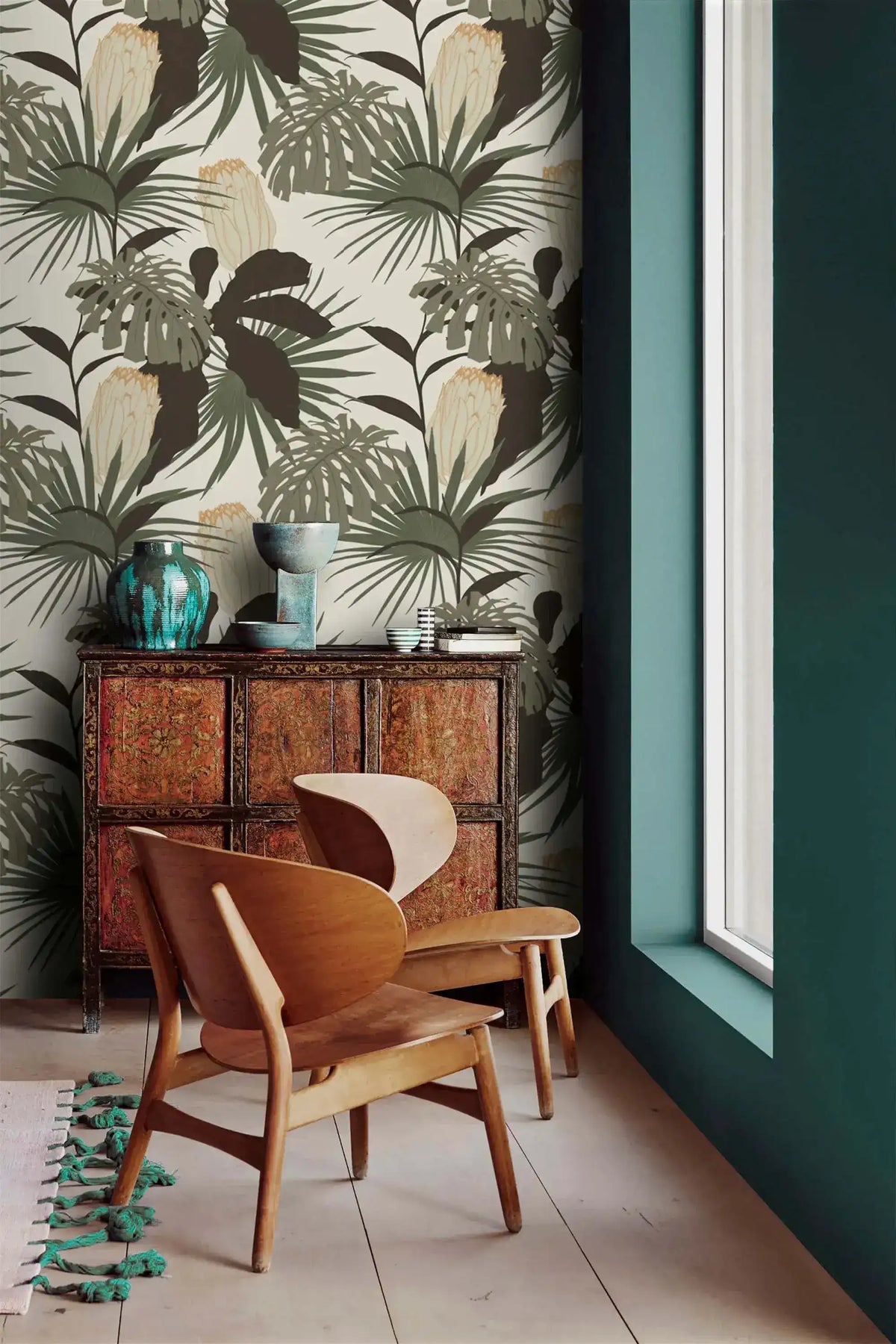 Vintage Glamour Palm Monstera wallpaper on accent wall; sage and dark leaves on cream beside teal wall and wood chair