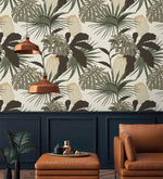 Vintage Glamour palm monstera wallpaper above navy wainscoting; copper pendants, tan leather armchair and ottoman below