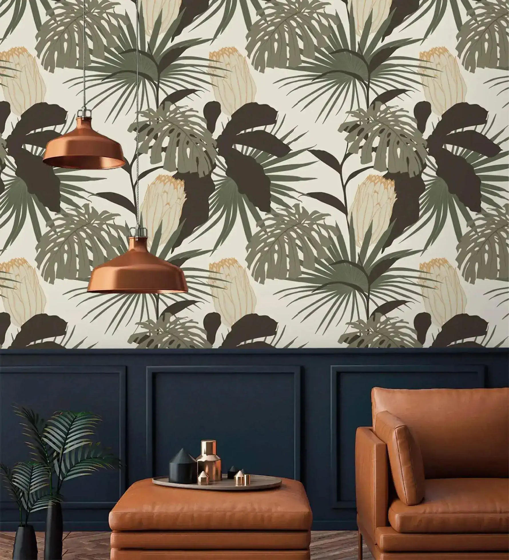 Vintage Glamour palm monstera wallpaper above navy wainscoting; copper pendants, tan leather armchair and ottoman below