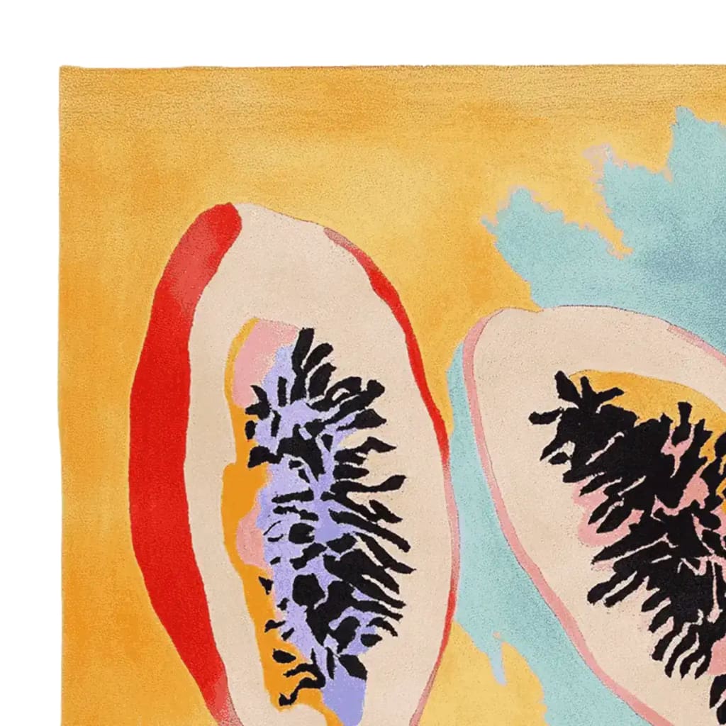 A vibrant hand-tufted area rug featuring an abstract depiction of papaya halves with rich colors like red, purple, and black on a warm yellow background. This contemporary wool rug is perfect for adding a splash of color to any living room area.