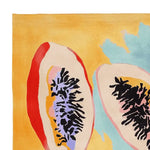 A vibrant hand-tufted area rug featuring an abstract depiction of papaya halves with rich colors like red, purple, and black on a warm yellow background. This contemporary wool rug is perfect for adding a splash of color to any living room area.