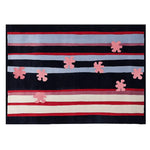 A contemporary wool area rug featuring a bold design with horizontal stripes in shades of red, blue, and white, accented by abstract pink floral shapes. Ideal for adding a modern touch to living room spaces.