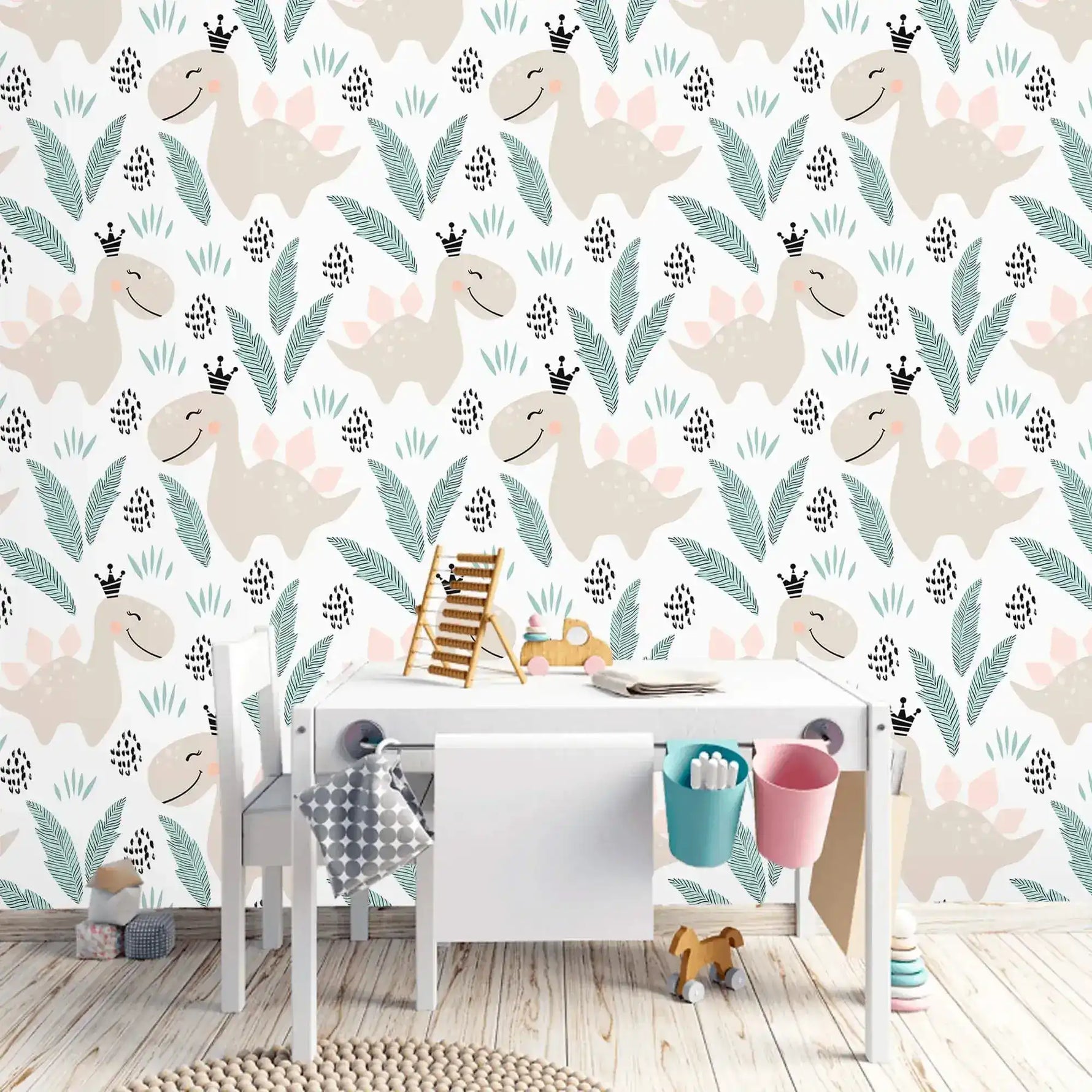 Pastel dino playground wallpaper with beige dinosaurs and leaves on white behind a child's white play desk