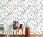 Pastel dino playground wallpaper close-up with smiling beige dinosaurs and leaves on white in a nursery