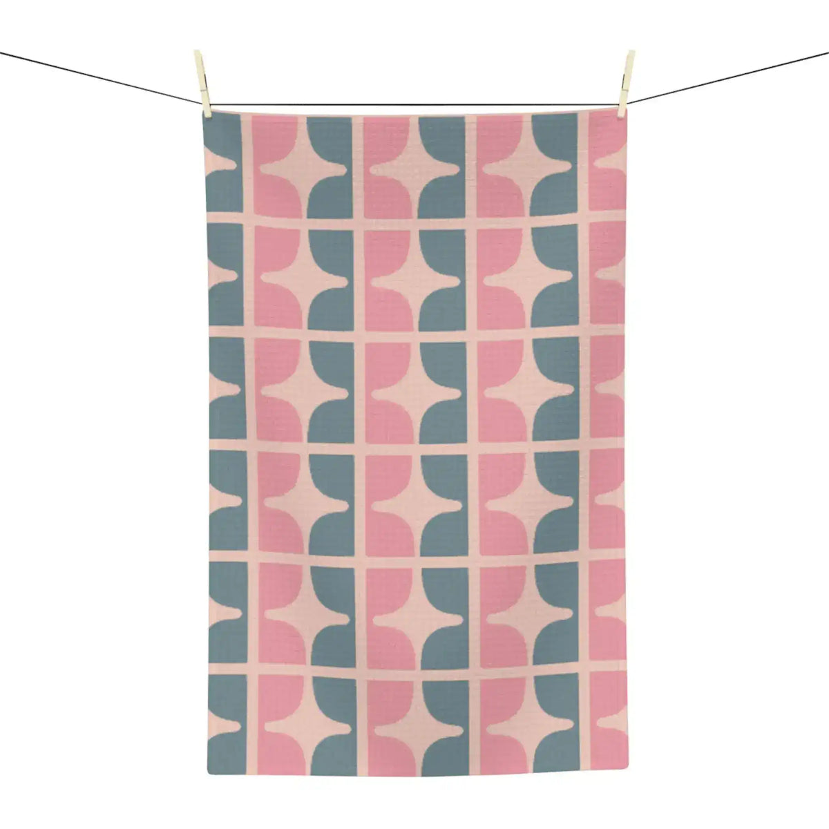 Pastel garden kitchen towel hung on a line, retro pink and slate blue geometric pattern