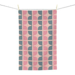 Pastel garden kitchen towel hung on a line, retro pink and slate blue geometric pattern